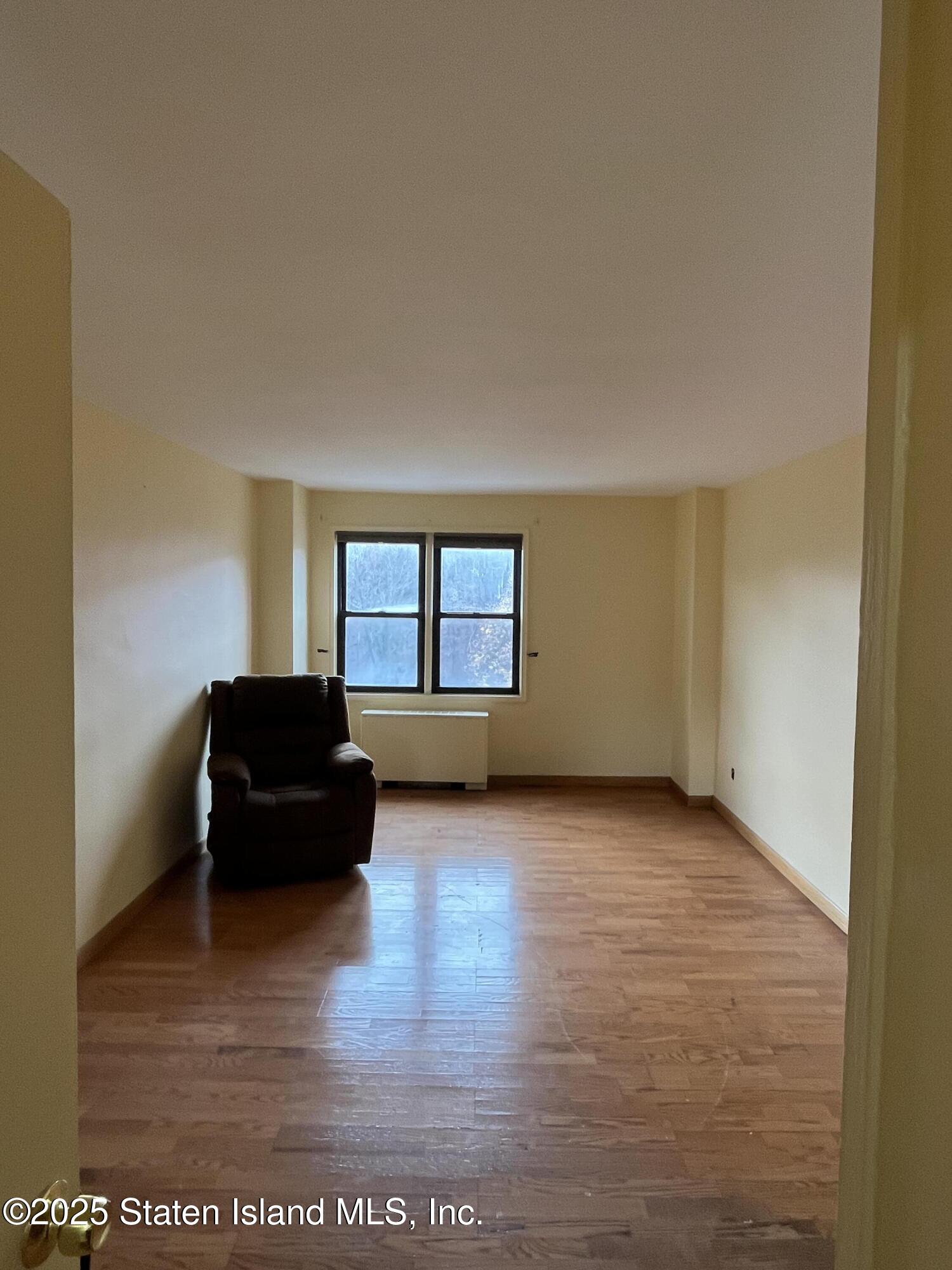 1000 Clove Road, Unit 4P Staten Island, NY 10301 - Photo 15 of 25 a living room with furniture and a window