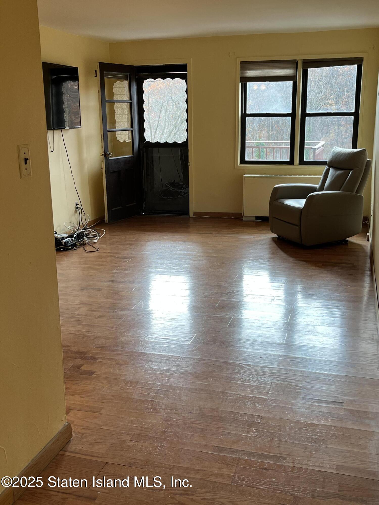 1000 Clove Road, Unit 4P Staten Island, NY 10301 - Photo 8 of 25 a living room with furniture window and wooden floor