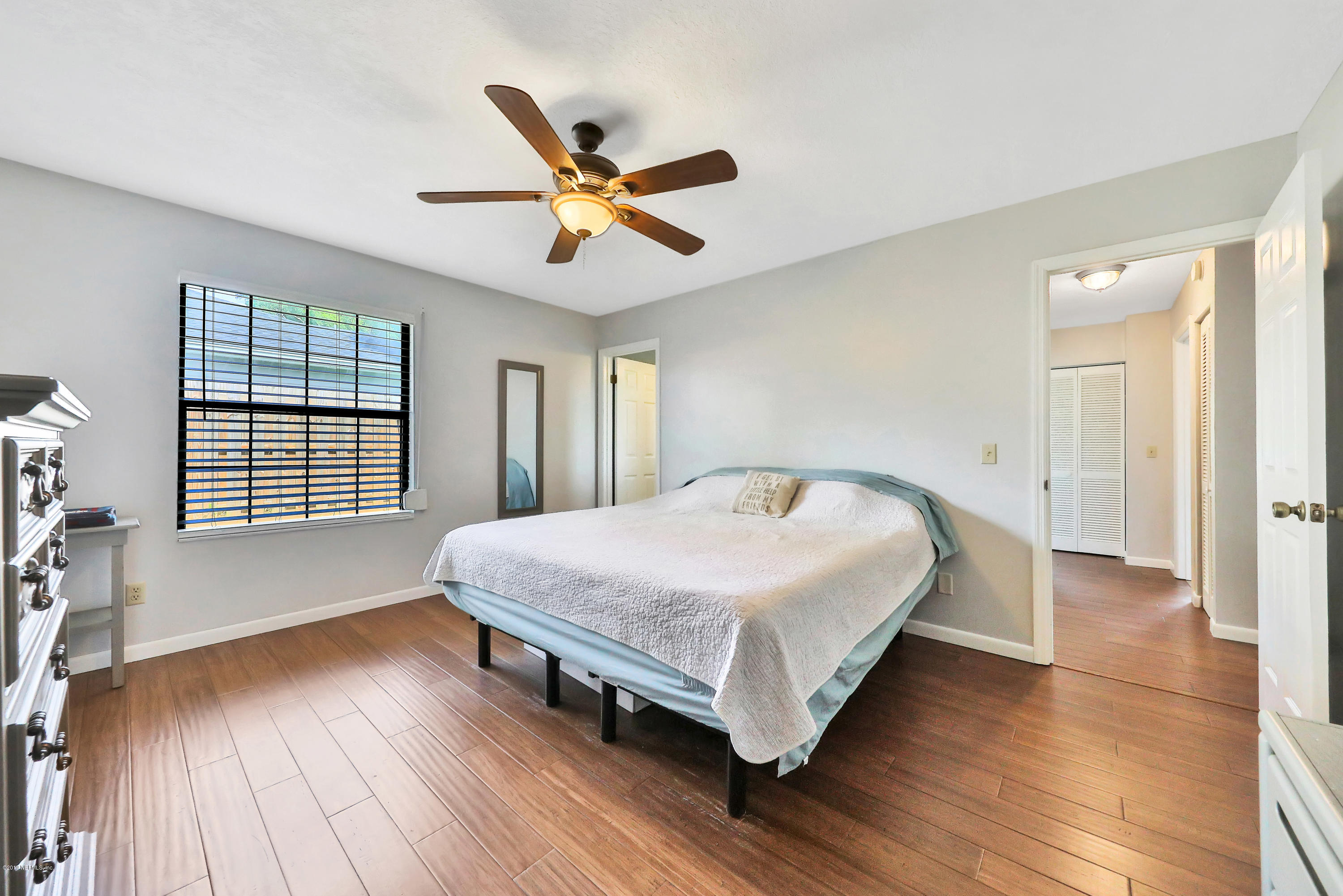 220 Hawthorne Road St. Augustine, FL 32086 - Photo 11 of 36 a spacious bedroom with a bed and wooden floor