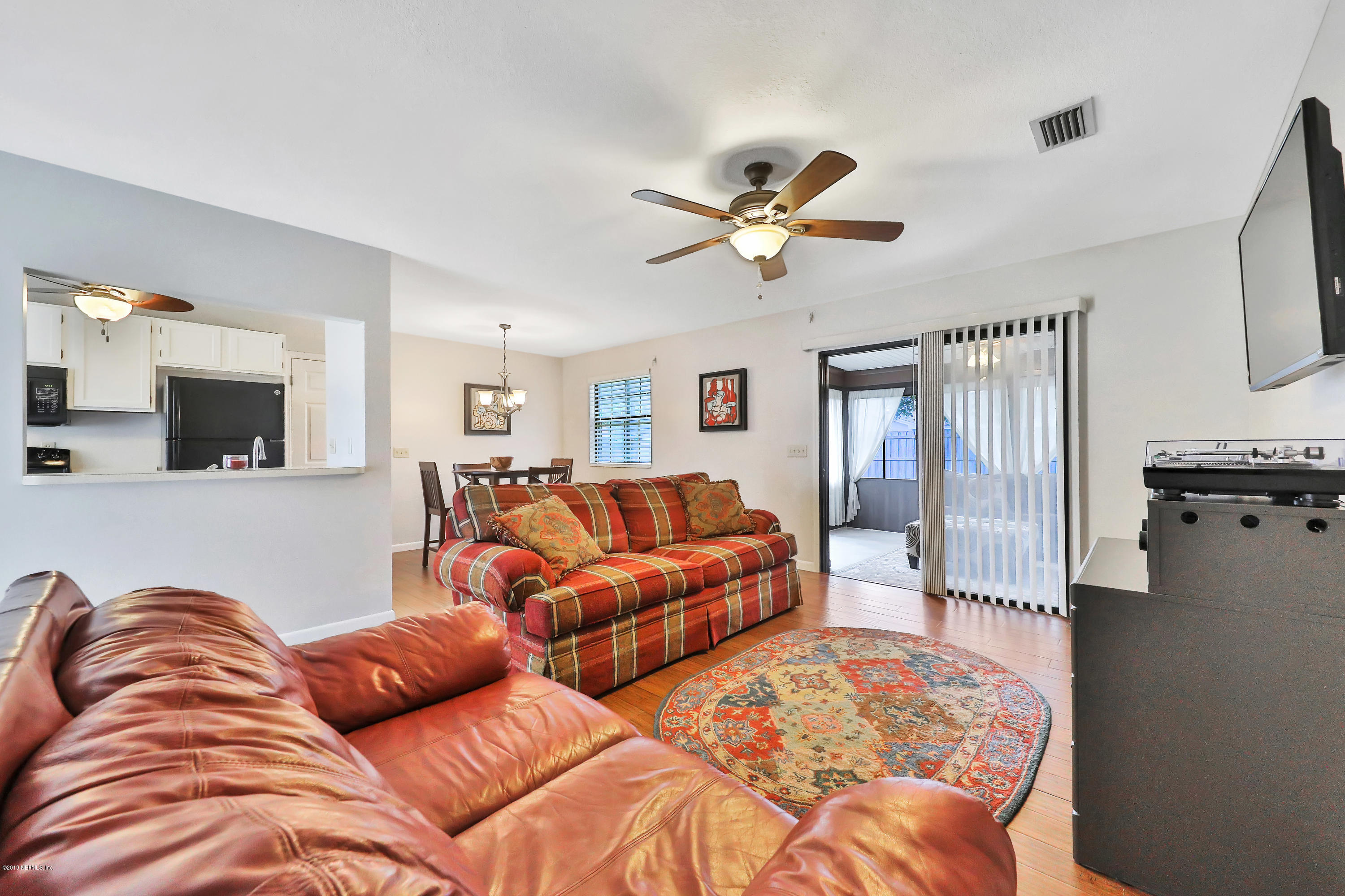 220 Hawthorne Road St. Augustine, FL 32086 - Photo 3 of 36 a living room with furniture ceiling fan and a rug