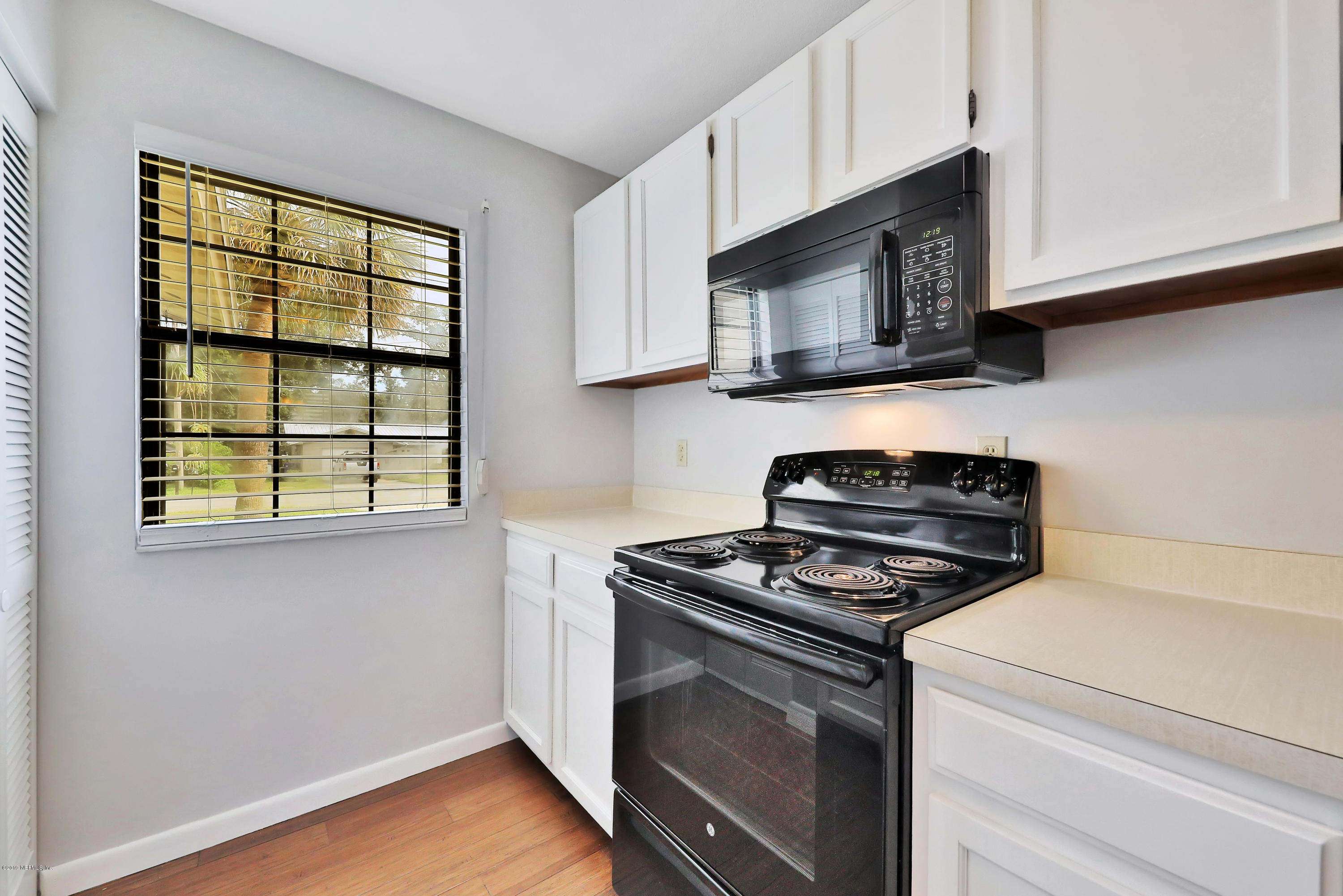 220 Hawthorne Road St. Augustine, FL 32086 - Photo 6 of 36 a kitchen with stainless steel appliances granite countertop white cabinets and a stove top oven