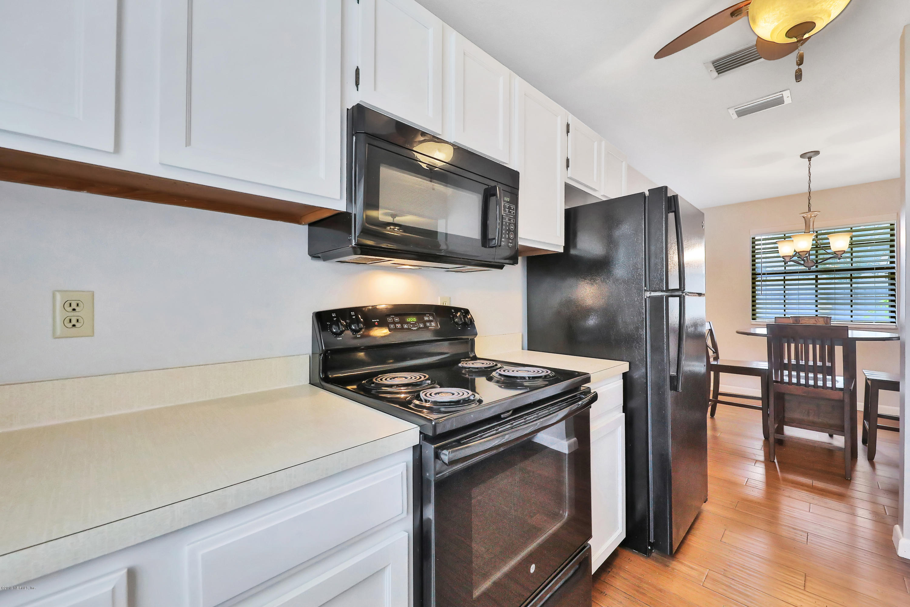 220 Hawthorne Road St. Augustine, FL 32086 - Photo 7 of 36 a kitchen with stainless steel appliances a stove microwave and refrigerator