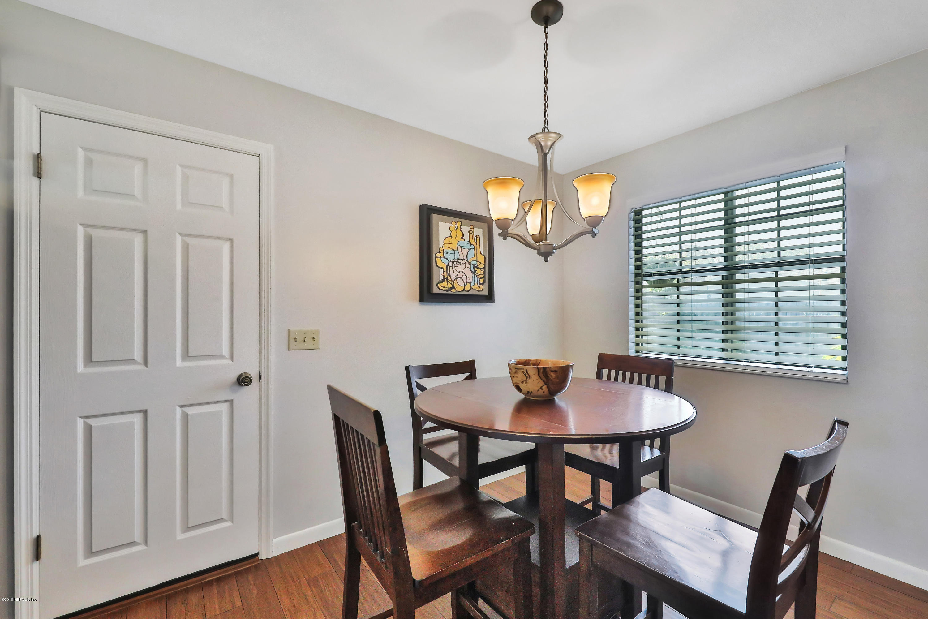 220 Hawthorne Road St. Augustine, FL 32086 - Photo 8 of 36 a view of a dining room with furniture window and wooden floor