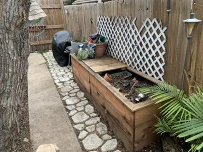 a view of a chairs and table in the back yard of the house