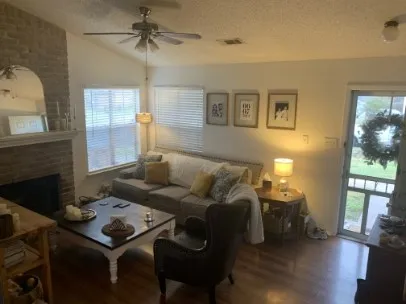 a living room with furniture and a fireplace
