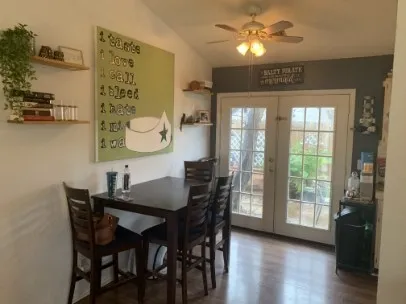 a view of a dining room with furniture and wooden floor