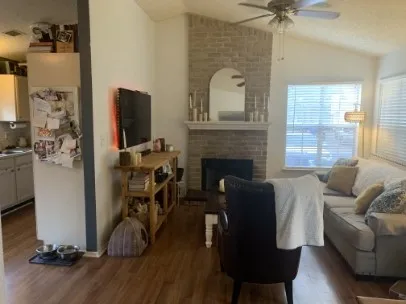 a living room with furniture and a fireplace