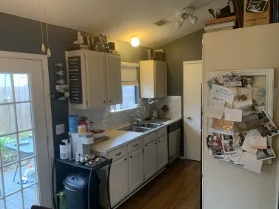 a kitchen with a sink stove and cabinets