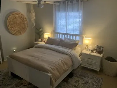a bedroom with a bed and lamp