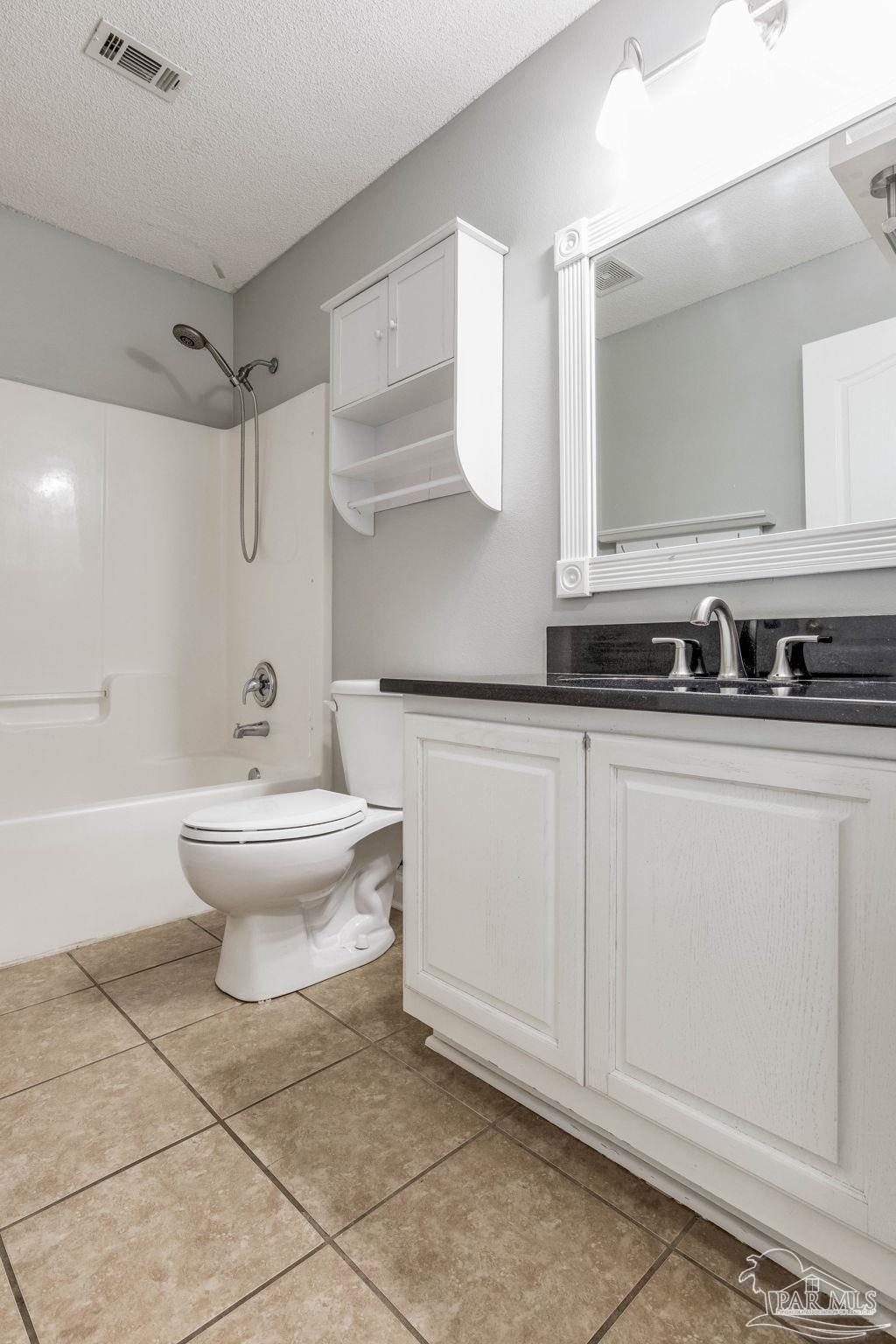 1068 Joaquin Road Pensacola, FL 32506 - Photo 12 of 23 a bathroom with a sink toilet and shower