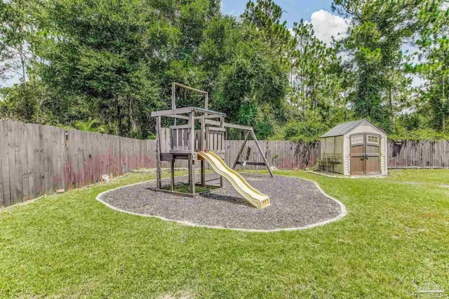 an aerial view of residential houses with outdoor space and swimming pool
