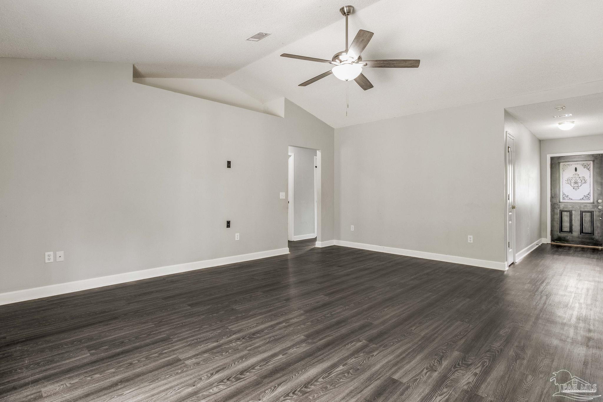 1068 Joaquin Road Pensacola, FL 32506 - Photo 4 of 23 a view of an empty room with wooden floor