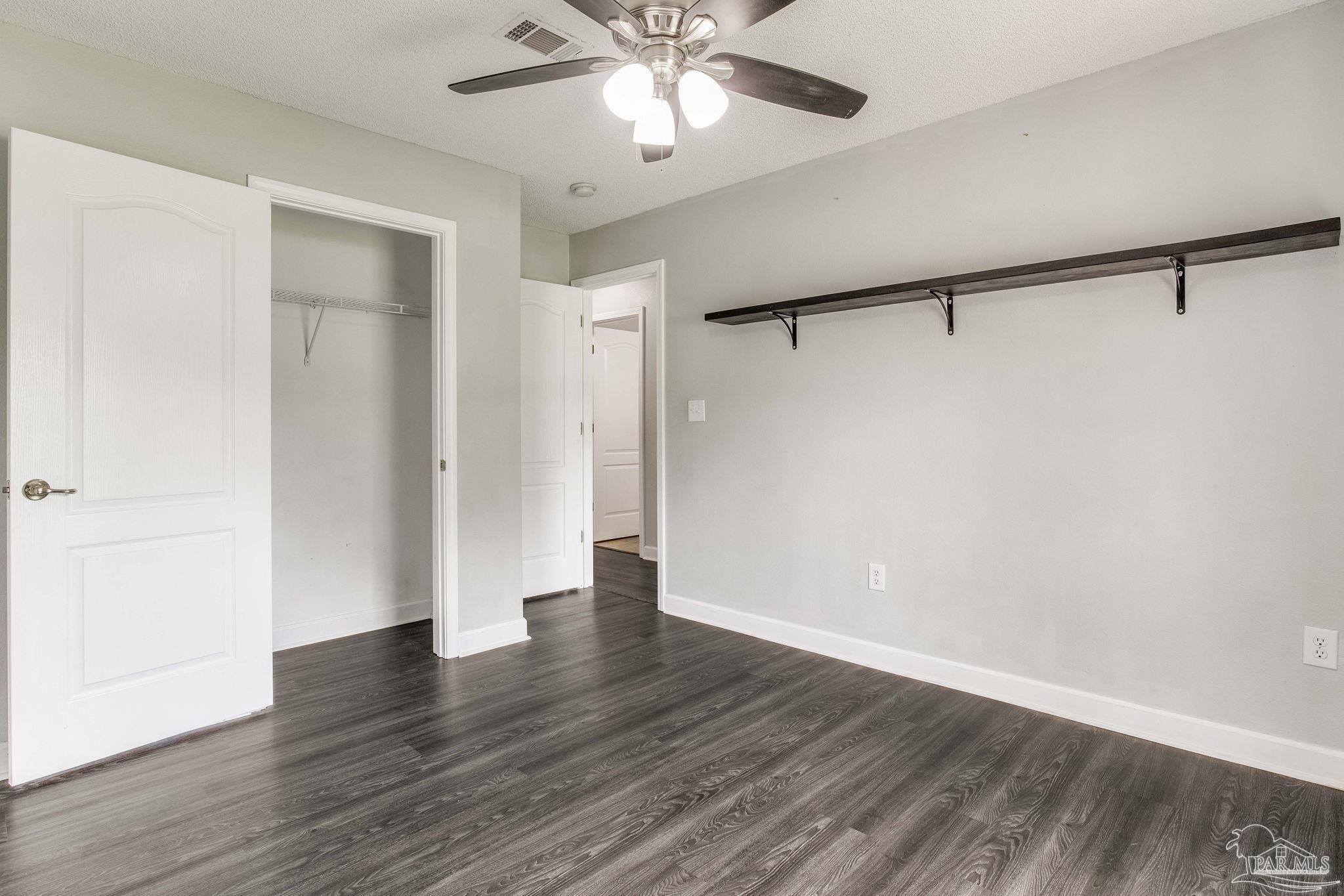 1068 Joaquin Road Pensacola, FL 32506 - Photo 10 of 23 a view of an empty room with wooden floor