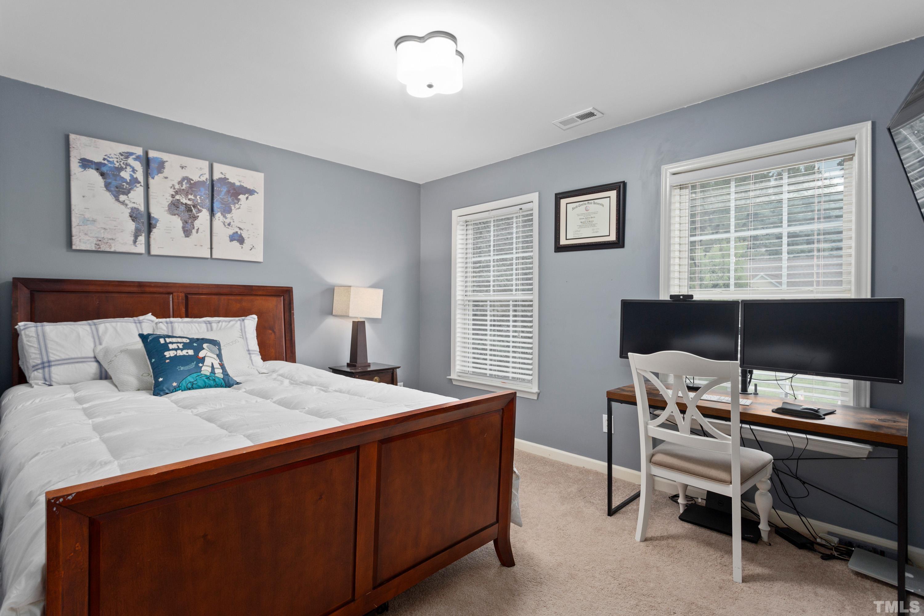 9229 Shallcross Way Raleigh, NC 27617 - Photo 24 of 38 a bedroom with a bed and a desk