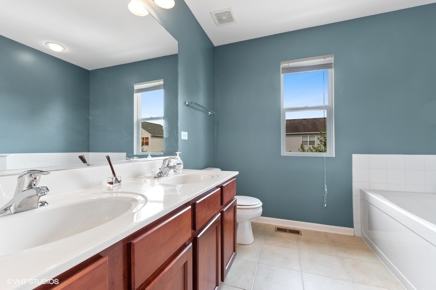 1417 Roth Drive Joliet, IL 60431 - Photo 11 of 18 a bathroom with a sink toilet and tub