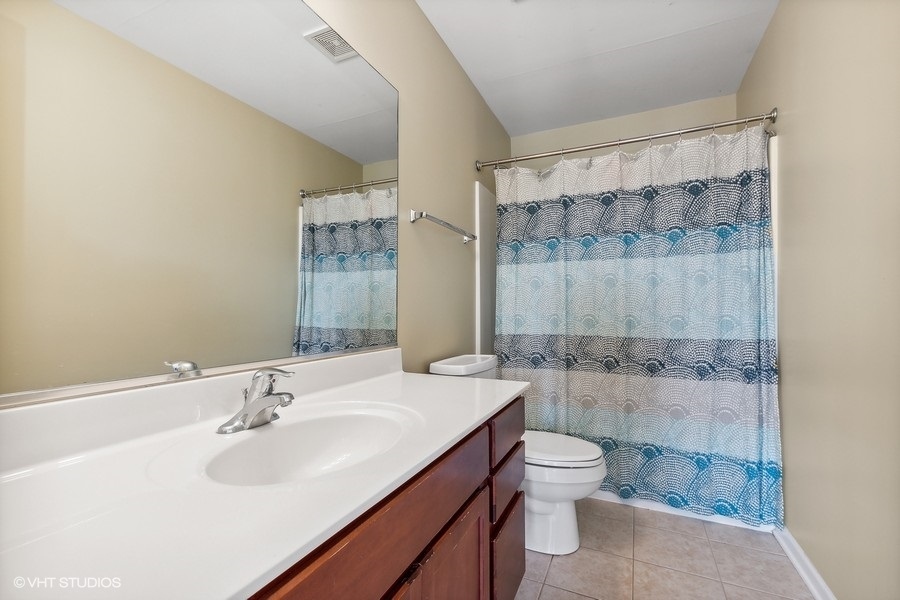 1417 Roth Drive Joliet, IL 60431 - Photo 16 of 18 a bathroom with a sink a toilet and shower