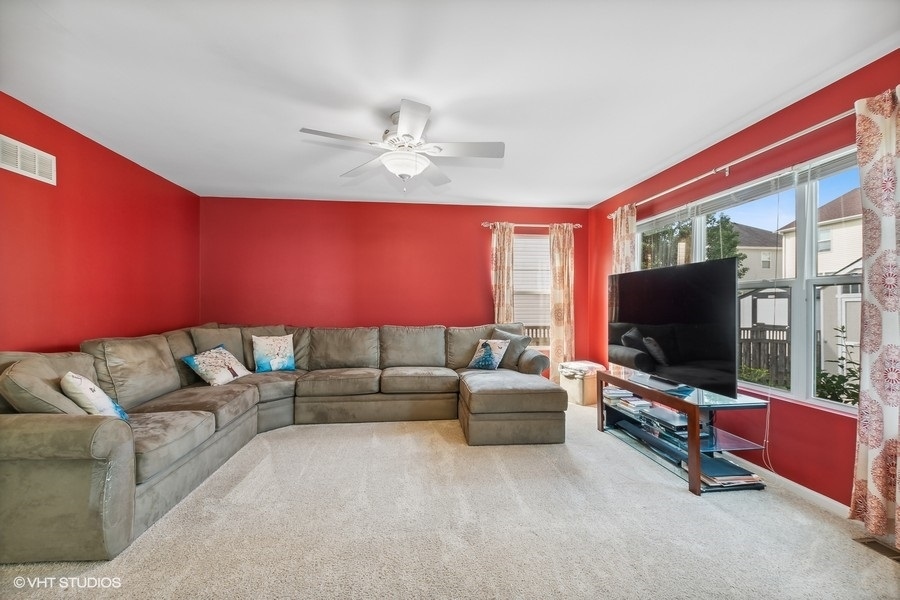 1417 Roth Drive Joliet, IL 60431 - Photo 7 of 18 a living room with furniture and a flat screen tv