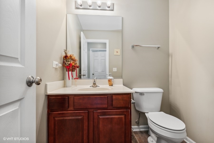 1417 Roth Drive Joliet, IL 60431 - Photo 8 of 18 a bathroom with a toilet a sink and mirror