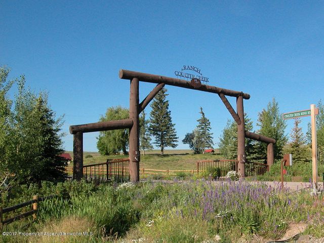 a view of a lush green hillside and a building