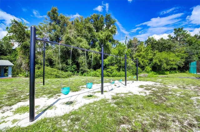 a view of a park with bench and trees