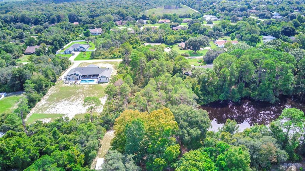 6067 Patricia Place Weeki Wachee, FL 34607 - Photo 16 of 21 an aerial view of residential house with outdoor space and trees all around