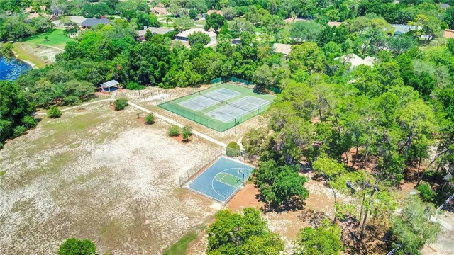 an aerial view of a house with a yard