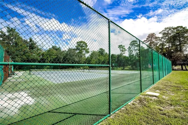 a view of a deck with a floor to ceiling window and wooden fence