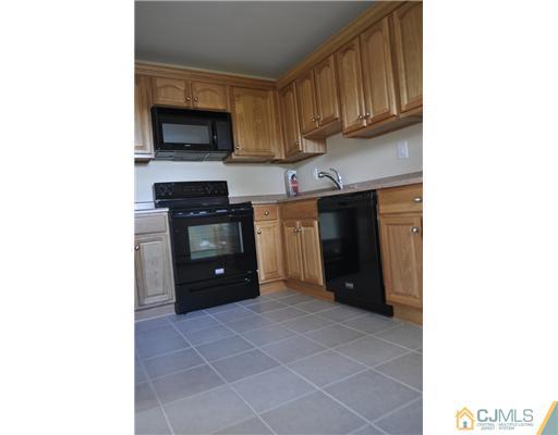 51 Farmingdale Road Fords, NJ 08863 - Photo 2 of 6 a kitchen with a sink and cabinets