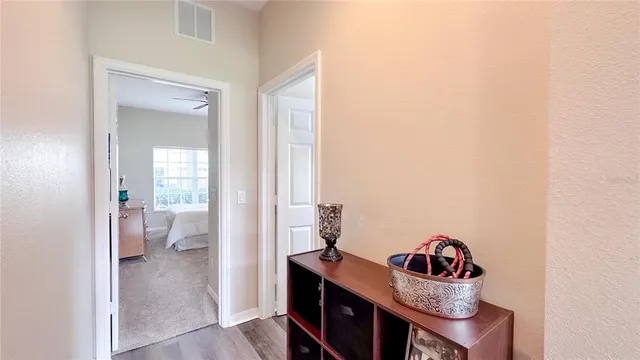 a view of a hallway to a livingroom and a dining room with a couch