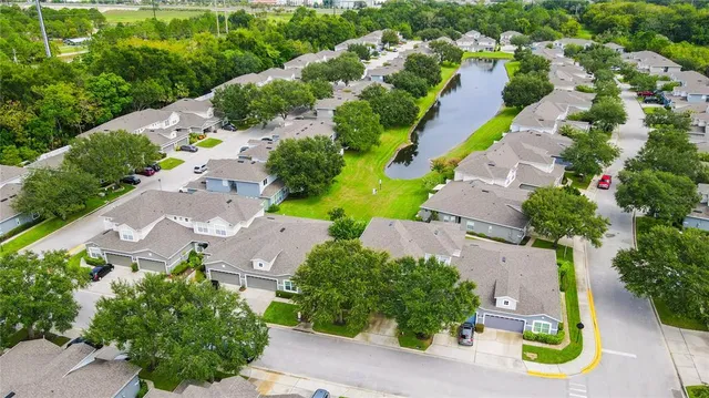 an aerial view of a house with a garden and swimming pool