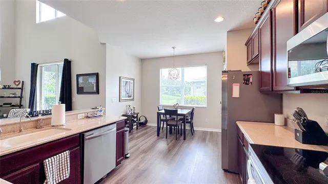 a large kitchen with lots of counter space a sink appliances and dining table