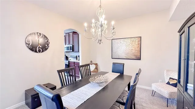 a view of a dining room with furniture wooden floor and chandelier
