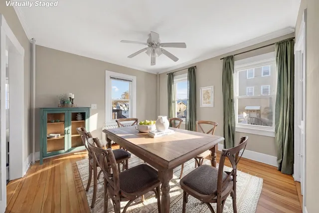 a view of a dining room with furniture window and wooden floor