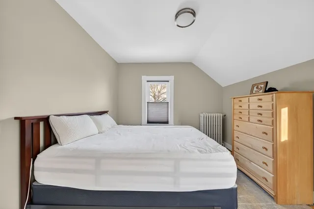 a bedroom with a bed and dresser