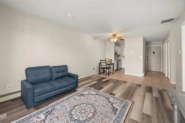 a living room with couch rug and a table