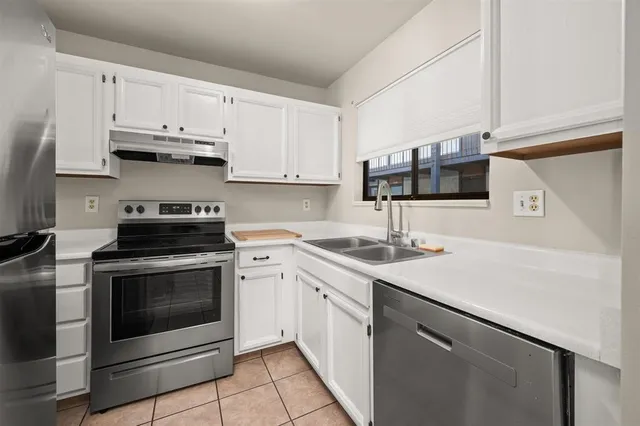 a kitchen with stainless steel appliances granite countertop a sink stove and cabinets