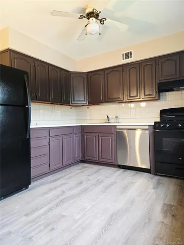 a kitchen with stainless steel appliances granite countertop a refrigerator and a stove top oven