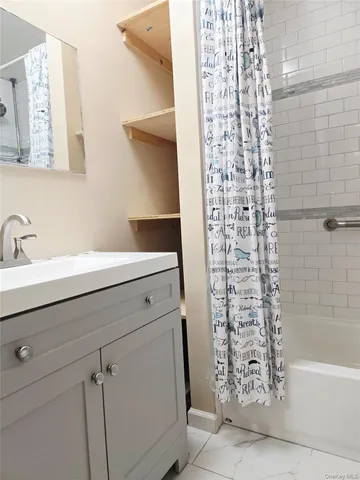 a bathroom with a sink a vanity and shower