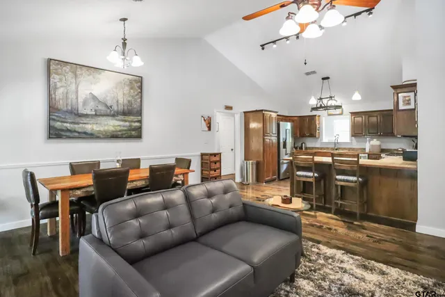 a bathroom with a granite countertop double vanity sink and a mirror