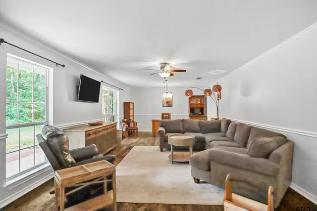 a living room with furniture and a flat screen tv