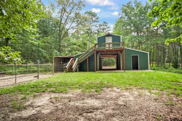a view of a house with a yard and sitting area