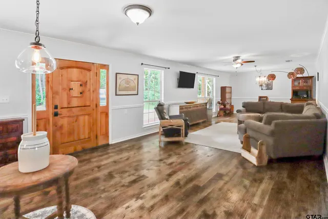 a living room with furniture and a chandelier