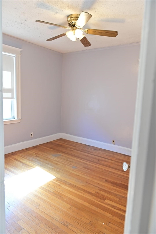 90 Elmer Road, Unit 2 Boston, MA 02124 - Photo 7 of 12 a view of empty room with wooden floor