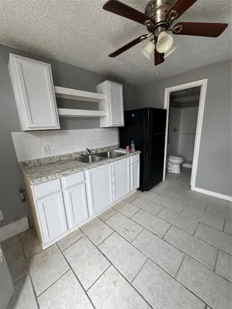 a kitchen with stainless steel appliances granite countertop a sink and a stove