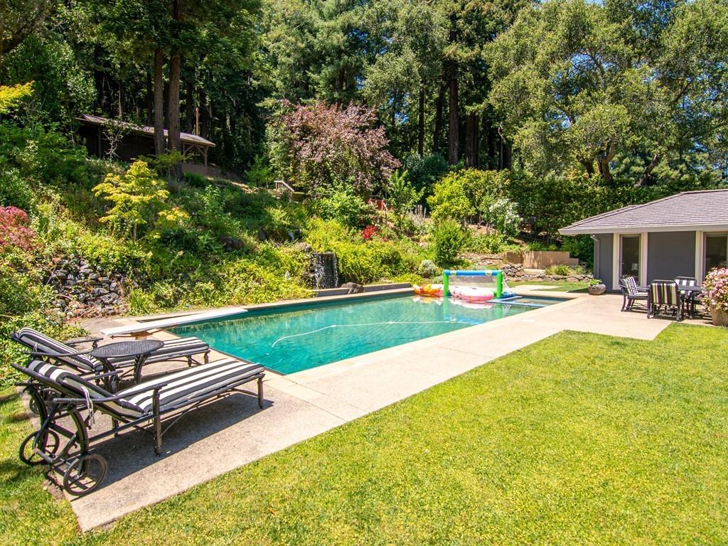 a swimming pool with outdoor seating and yard