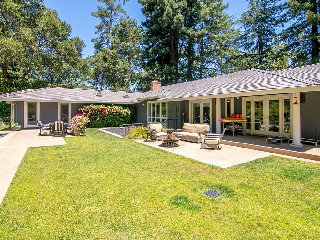 3600 Tripp Road Woodside, CA 94062 - Photo 26 of 27 a view of a patio with table and chairs under an umbrella