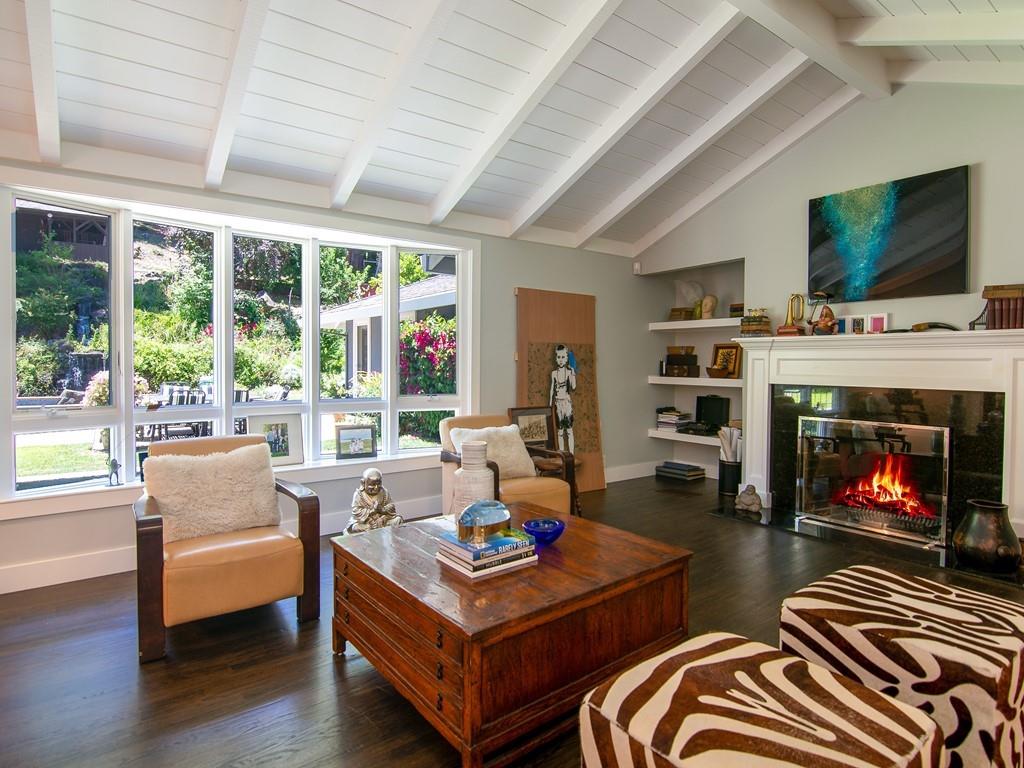 3600 Tripp Road Woodside, CA 94062 - Photo 4 of 27 a living room with furniture a flat screen tv and a fireplace