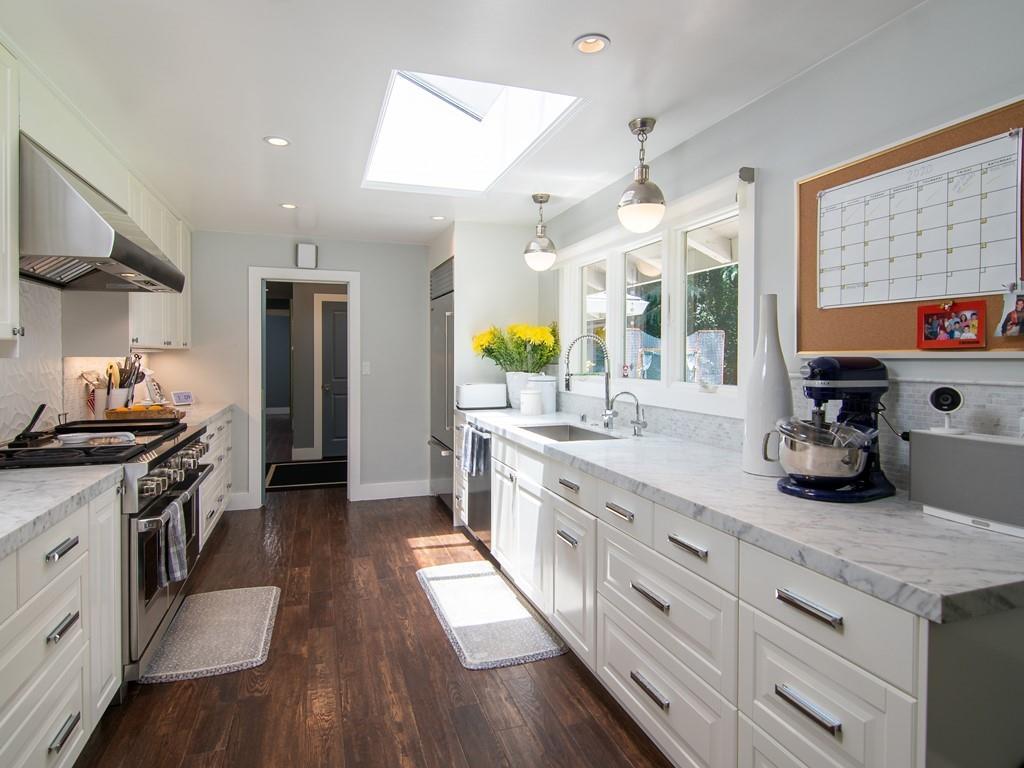 3600 Tripp Road Woodside, CA 94062 - Photo 8 of 27 a kitchen with stainless steel appliances granite countertop a stove a sink dishwasher a refrigerator and a dining table with wooden floor