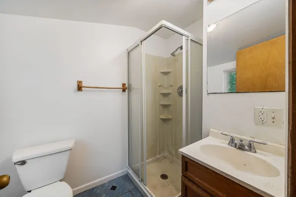 a bathroom with a sink mirror toilet and shower