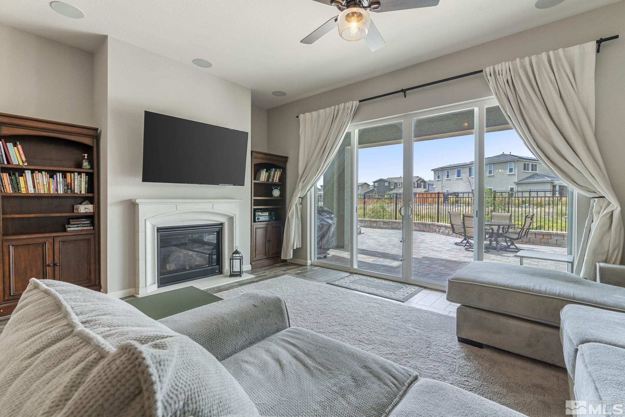 2305 Buttermere Drive Reno, NV 89521 - Photo 11 of 39 a living room with furniture a fireplace and a flat screen tv